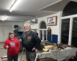Grand nephew Ryker Shappy (left) standing with Dick Shappy in front of the 1917 Reading Standard Model T-E 12 HP Twin project. Note the frame, gas tank, and fenders in the foreground.